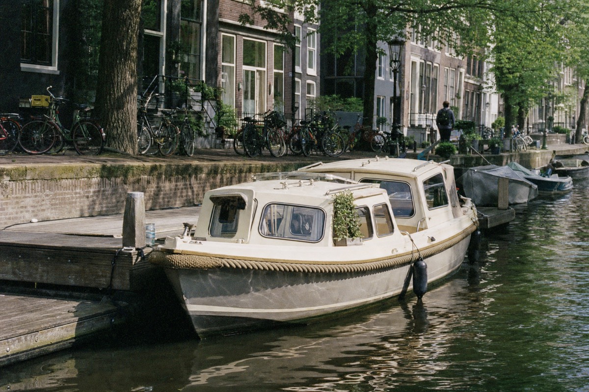 A canal boat moored at a jetty on the Prinsengracht in Amsterdam, no text, no logos, no people.